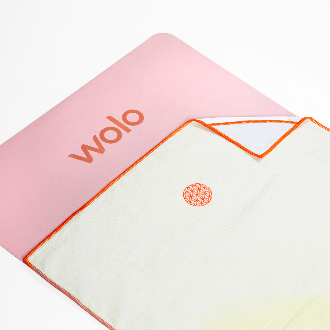 orange yoga towel on a pink yoga mat#color_solar blaze