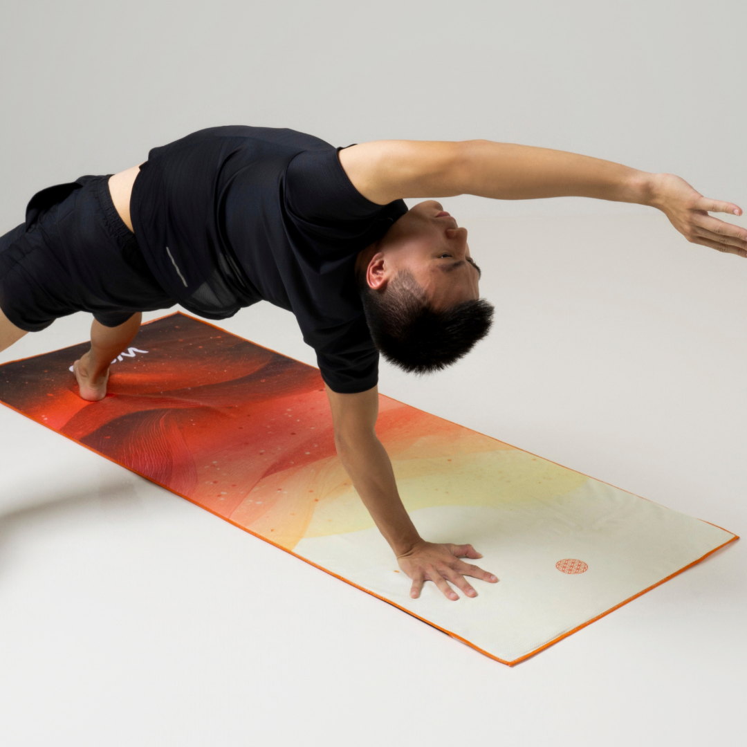 person practicing yoga on an orange yoga towel#color_solar blaze