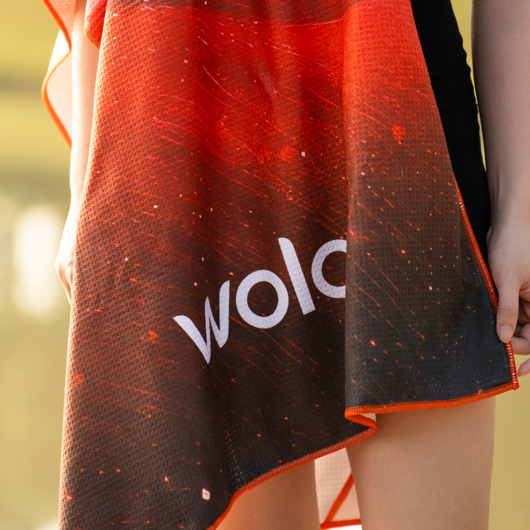 person holding a black and red gradient yoga towel#color_solar blaze