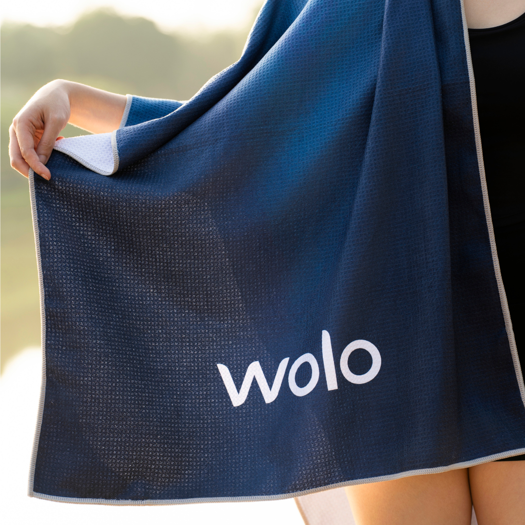 person holding a blue yoga towel#color_lunar radiance
