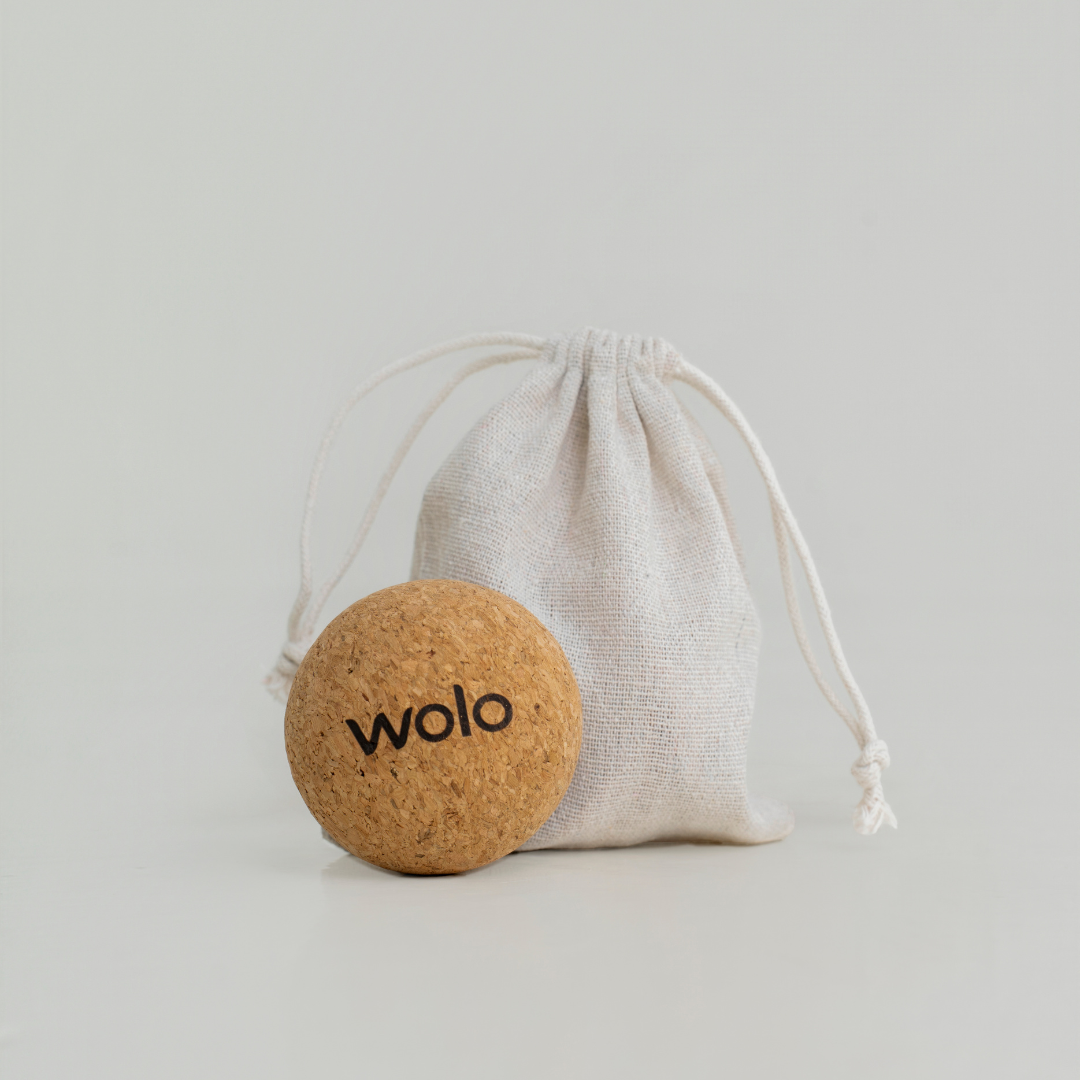 Cork massage ball with 'wolo' branding on a gray background