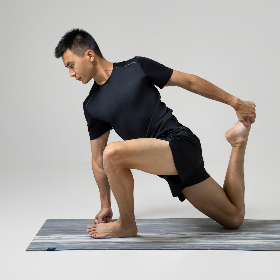 Person performing a yoga pose on a grey yoga mat#color_limestone grey