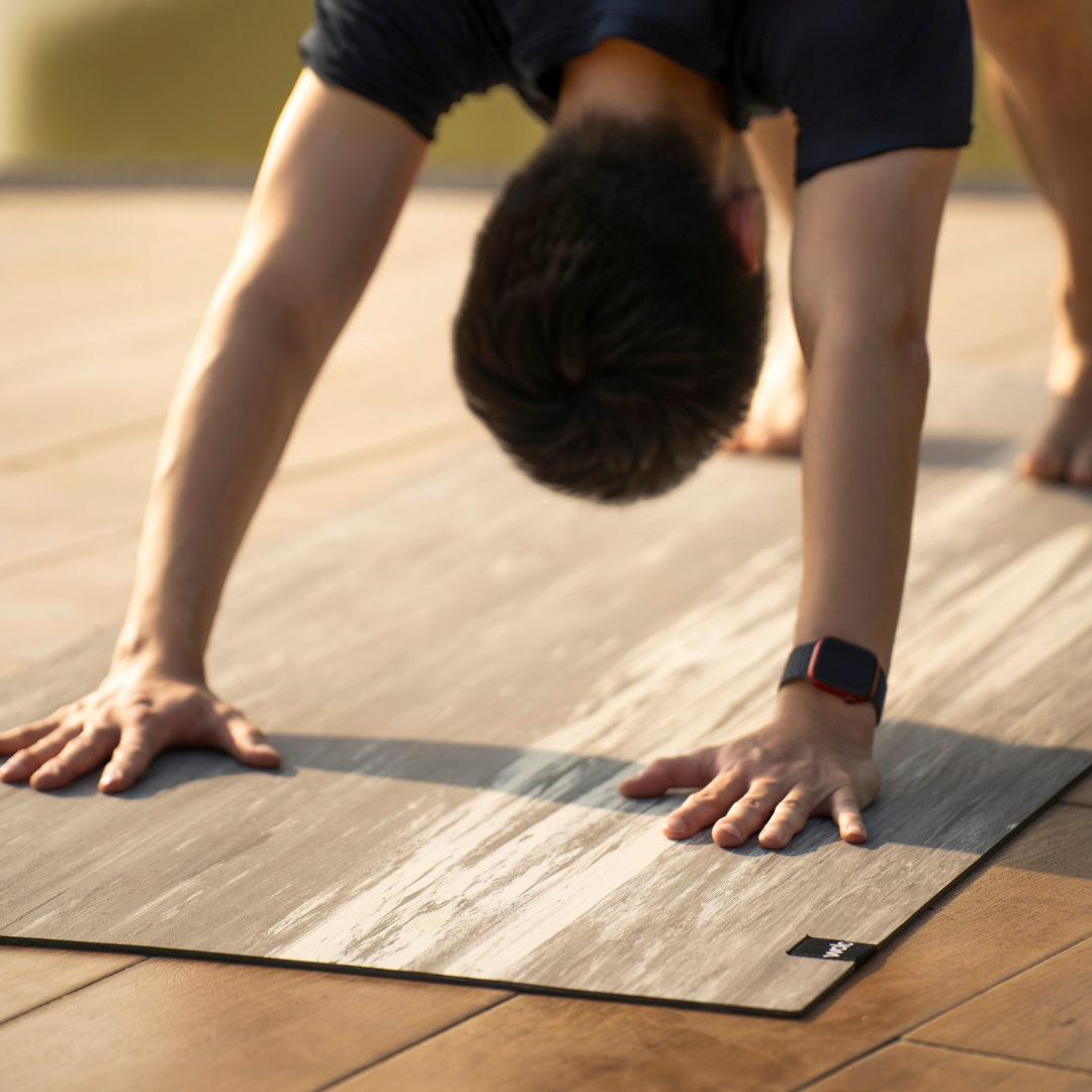 Person doing a handstand on a yoga mat outdoors#color_limestone grey