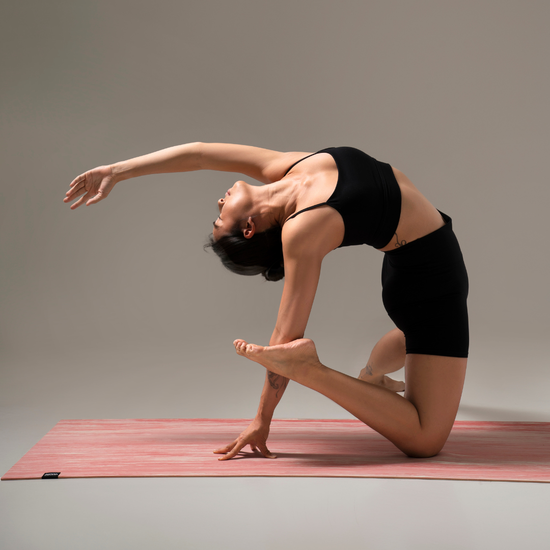 Person practicing yoga on a pink yoga mat#color_unakite pink
