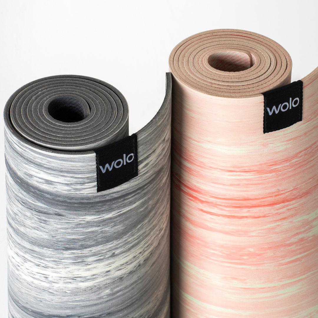 Two rolled-up yoga mats with 'wolo' branding on a white background