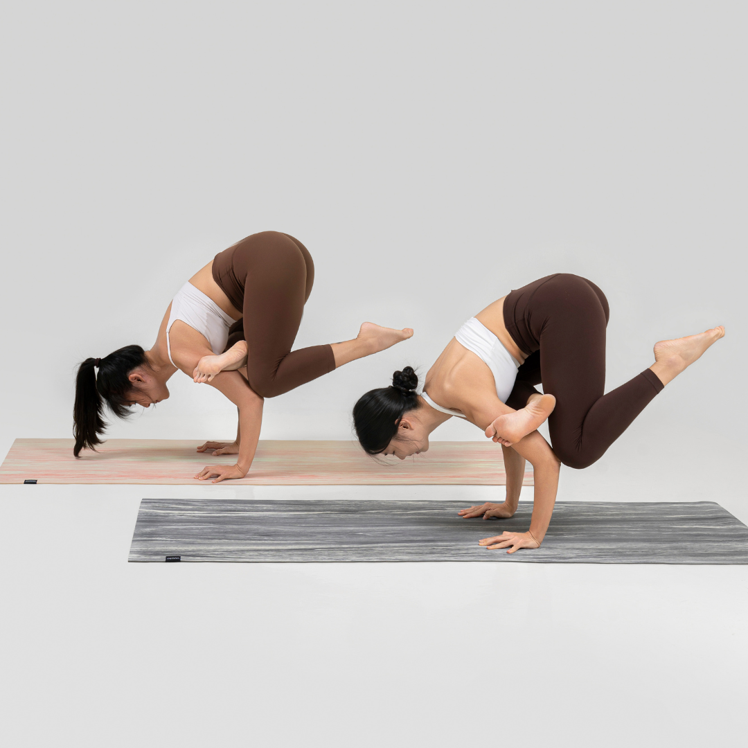 Two yoga teachers performing arm balance figure 4 crow pose on Wolo Ascend Yoga Mat
