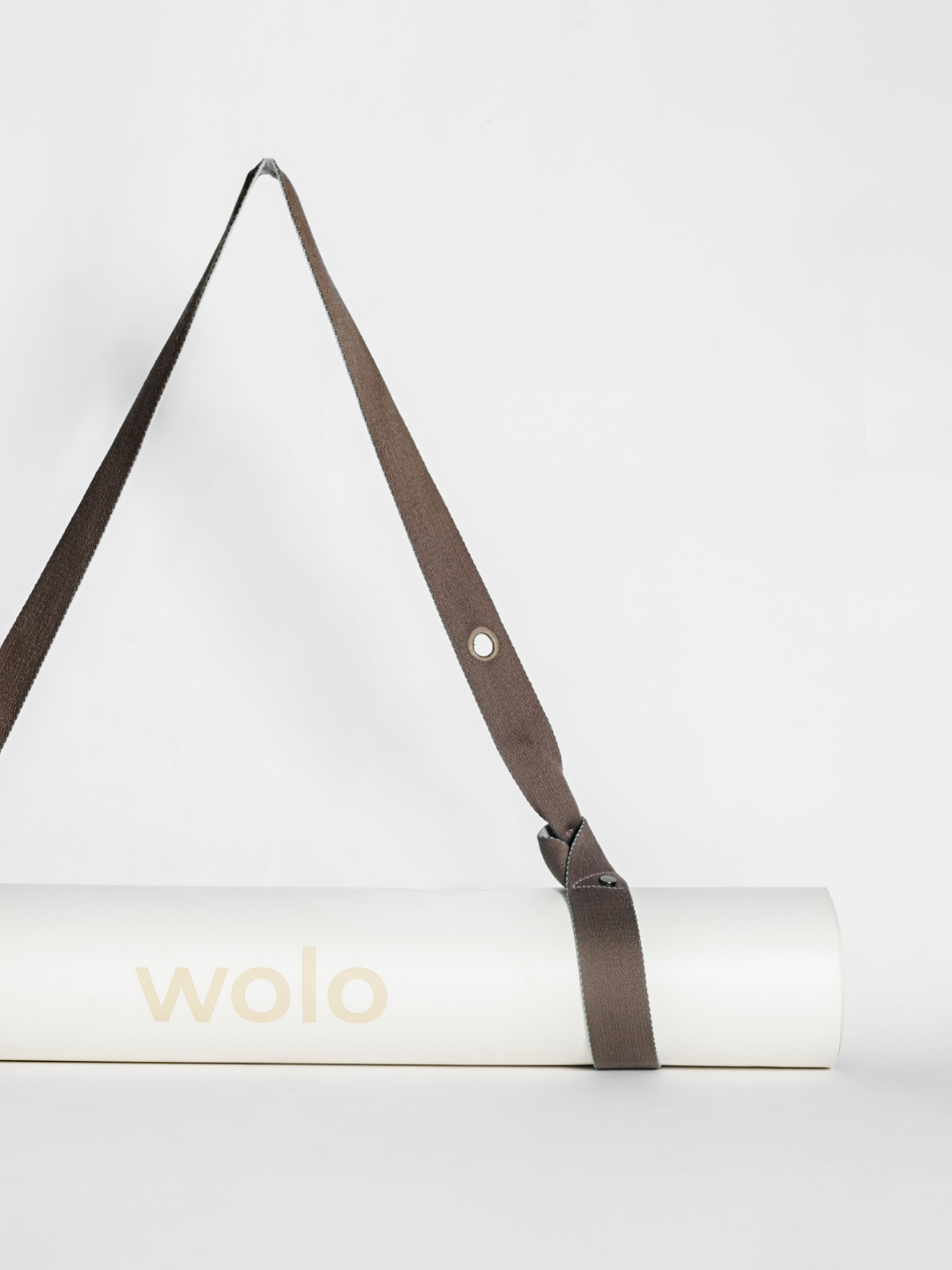White yoga mat with a Mint green On The Go yoga mat strap