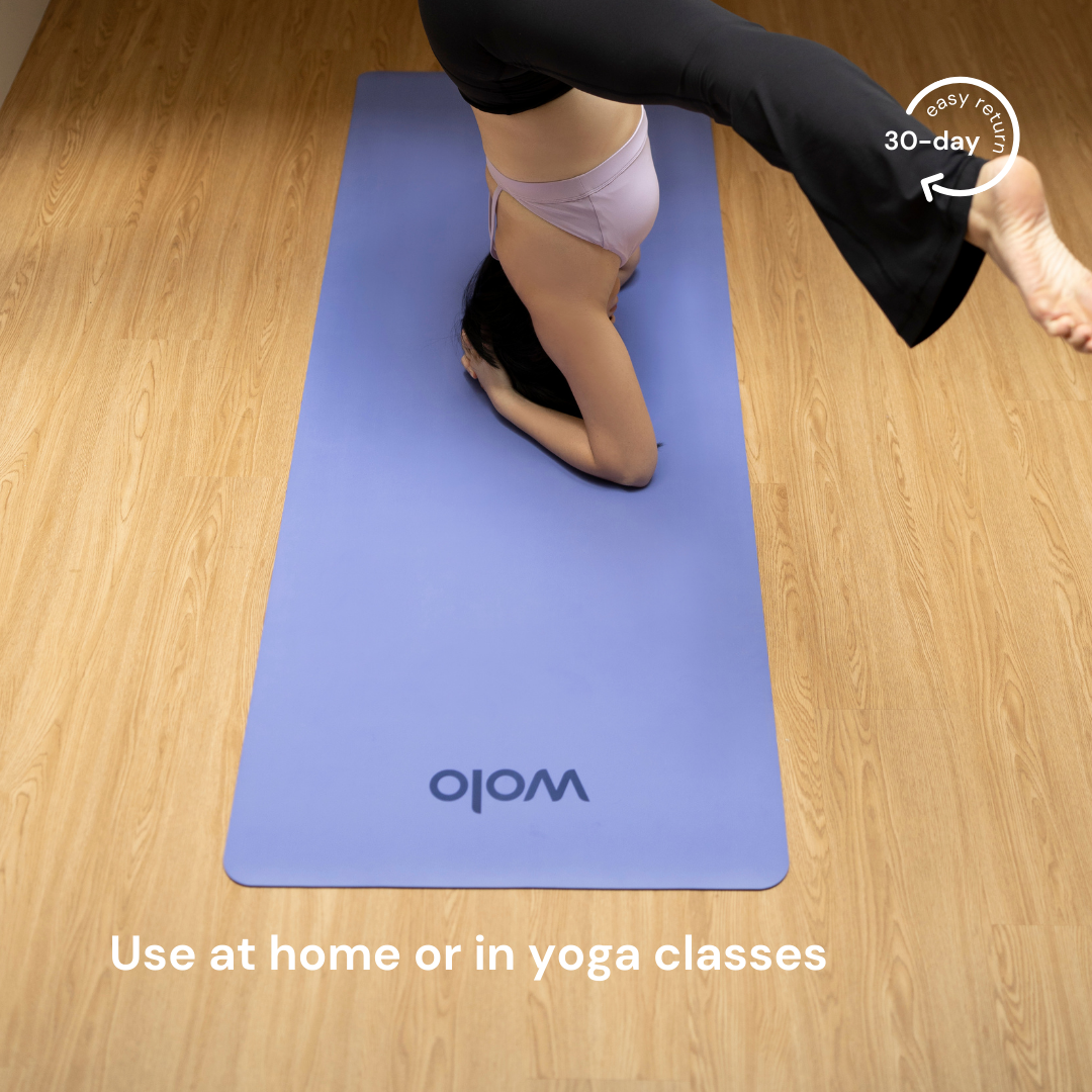 Headstand on the lilac purple yoga mat