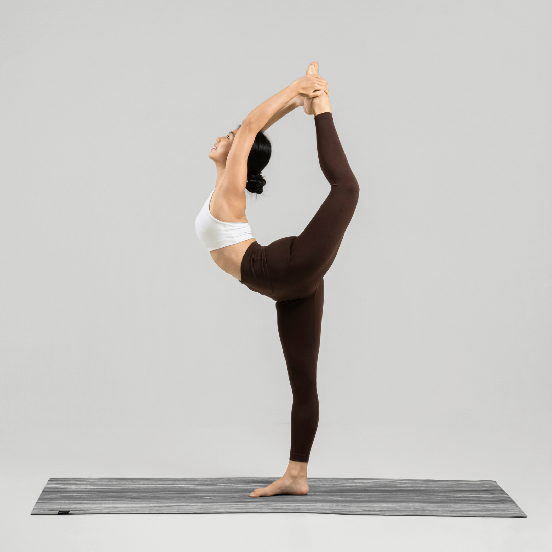 Girl performing a yoga king dancer pose on an ascend mat#color_limestone grey