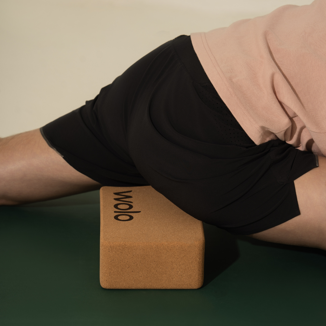 man using yoga block support pigeon pose