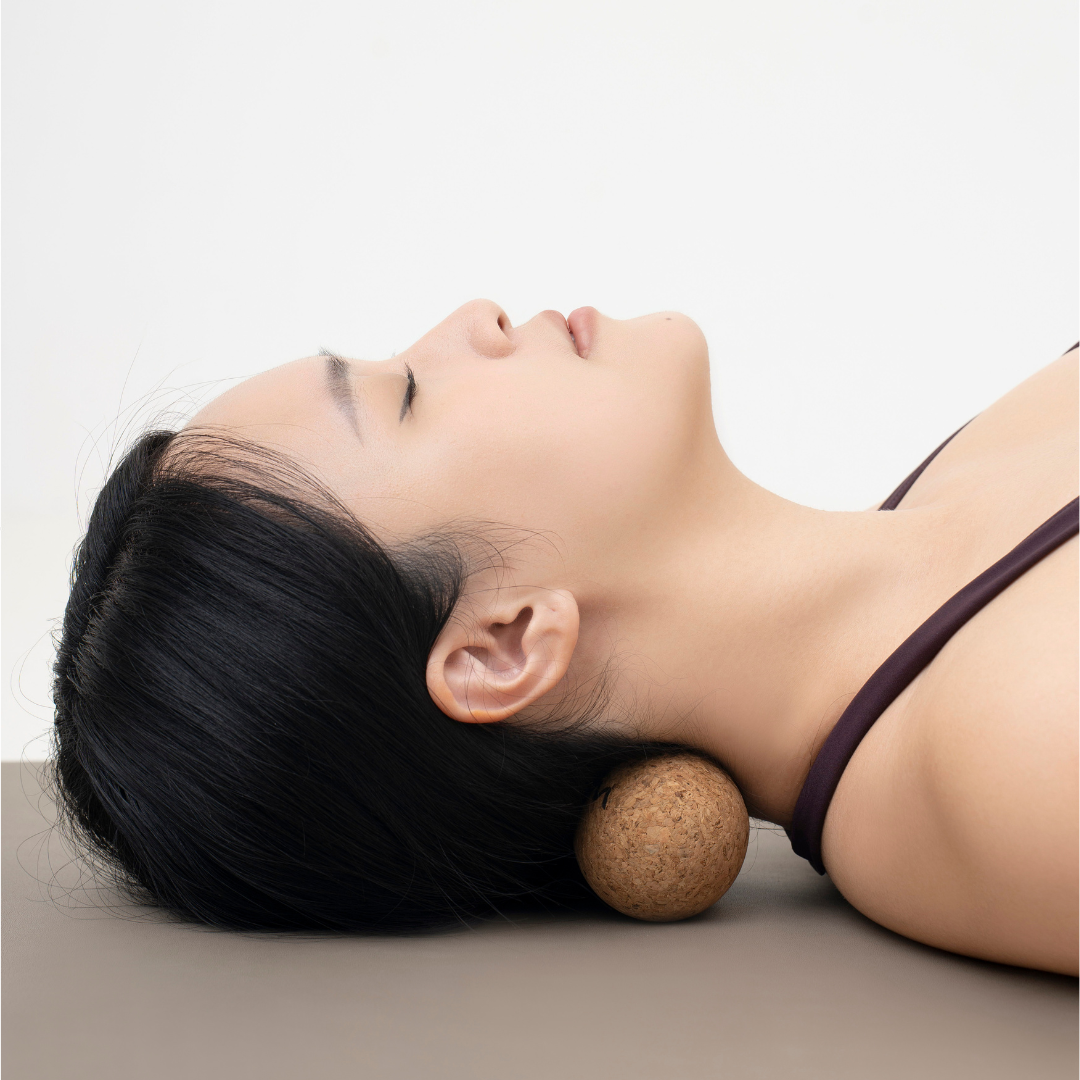 Neck release using a cork peanut massage ball