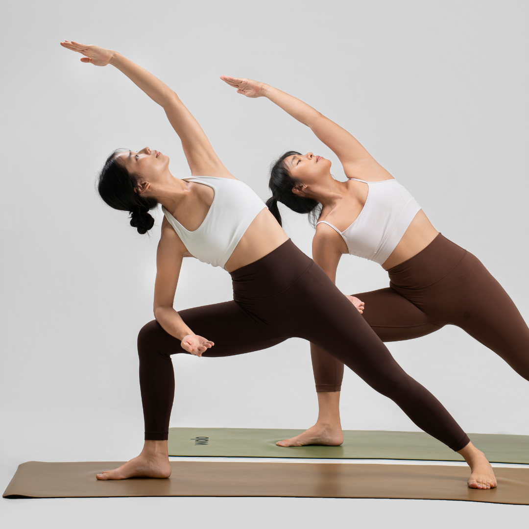 Two women performing a yoga side angle pose on a Wolo Mastery Yoga Mats