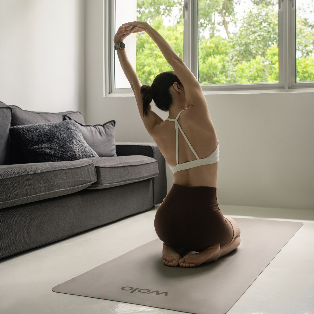 stretching on the away travel earth beige yoga mat